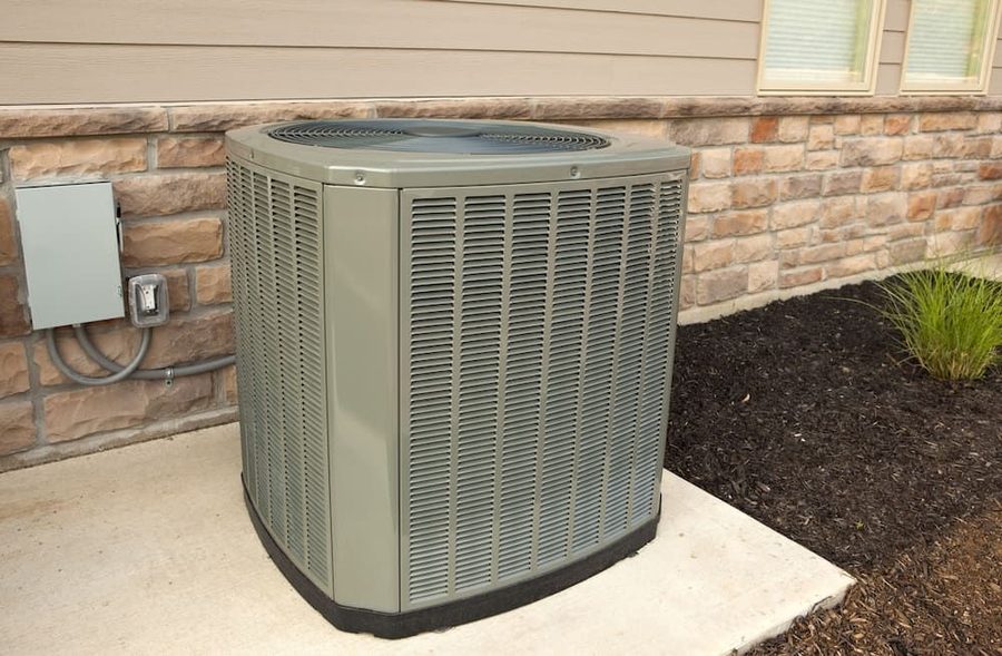 Outdoor air conditioning system in concrete slab next to the house